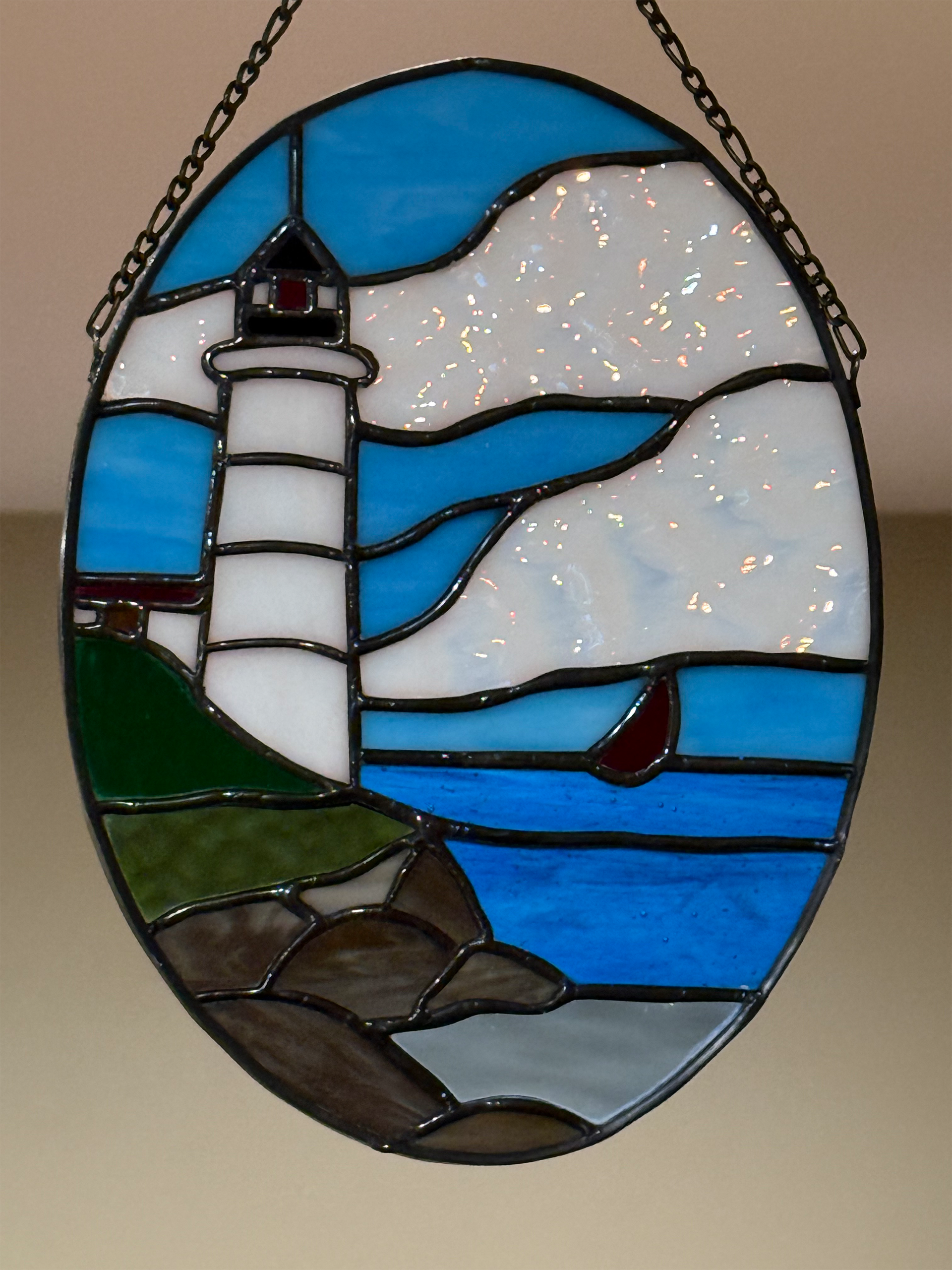 Nubble lighthouse and sailboat stained glass suncatcher